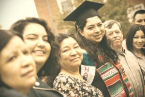 Yesenia Ortiz at graduation surrounded by family.