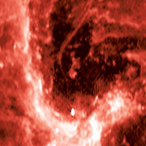 A radio image from the NSF’s Karl G. Jansky Very Large Array showing the center of our galaxy. The mysterious radio filament is the curved line located near the center of the image, and the supermassive black hole Sagittarius A* (Sgr A*) is shown by the bright, egg-shaped source near the bottom of the image.