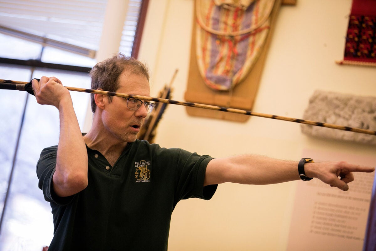 During Wintersession, students learn to make and use the technology that revolutionized human life. The atlatl, or spear-thrower, is a 10,000-year-old tool developed independently across the globe by cultures from the Arctic to New Zealand. The workshop takes place in the Peabody Museum at Harvard University. Andrew Majewski (pictured), the workshop instructor, demonstrates how to throw an atlatl during the workshop. 