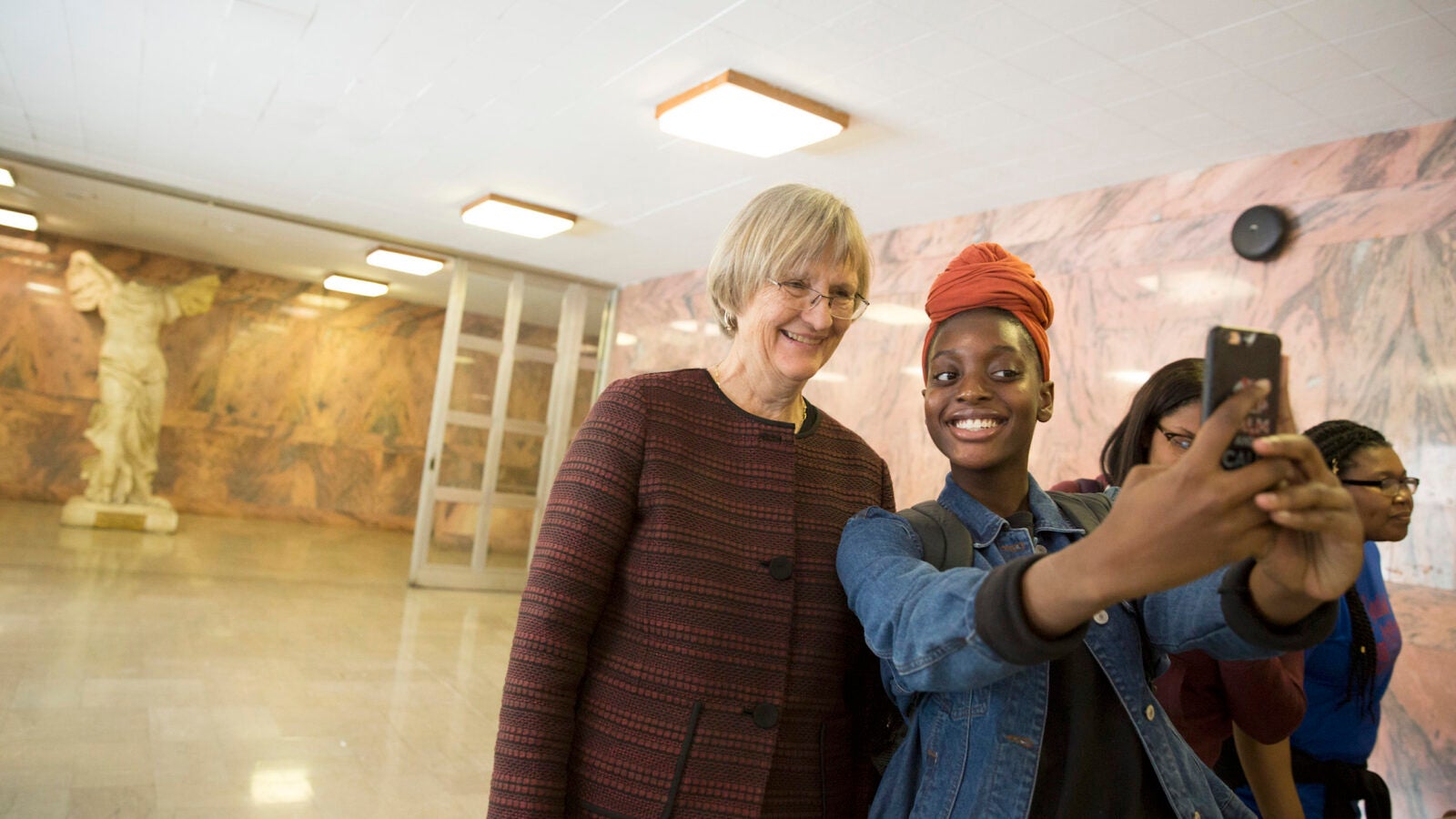  “It feels good to know that somebody of her stature wants to come to speak to us,” said Amanda Smith, pictured taking a selfie with Harvard President Drew Faust.