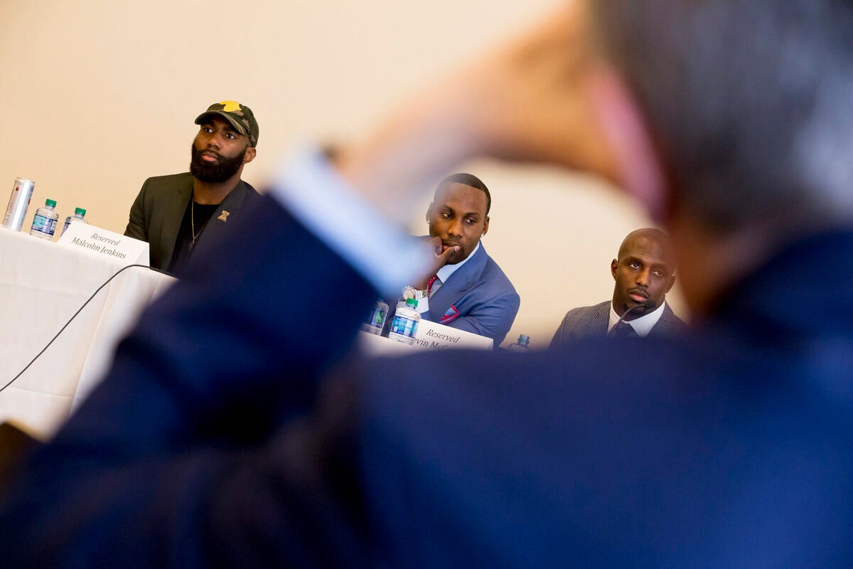 Current and former NFL players Malcolm Jenkins (from left), Anquan Boldin, and Devin McCourty came to Harvard Law School as part of the National Football League Player's Coalition project to promote social justice. 