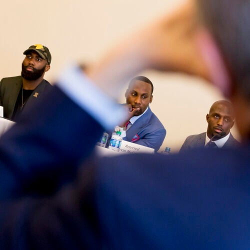 Current and former NFL players Malcolm Jenkins (from left), Anquan Boldin, and Devin McCourty came to Harvard Law School as part of the National Football League Player's Coalition project to promote social justice. 