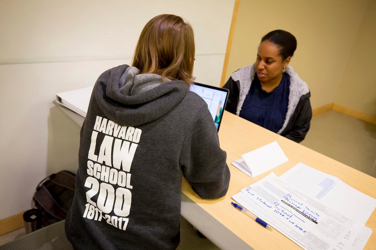 Rebekah Holtz, J.D. '19 (left), assists Claire Gauthier of Newton with her taxes as part of Harvard TaxHelp, a student-run organization that offers free assistance to low-income clients. 