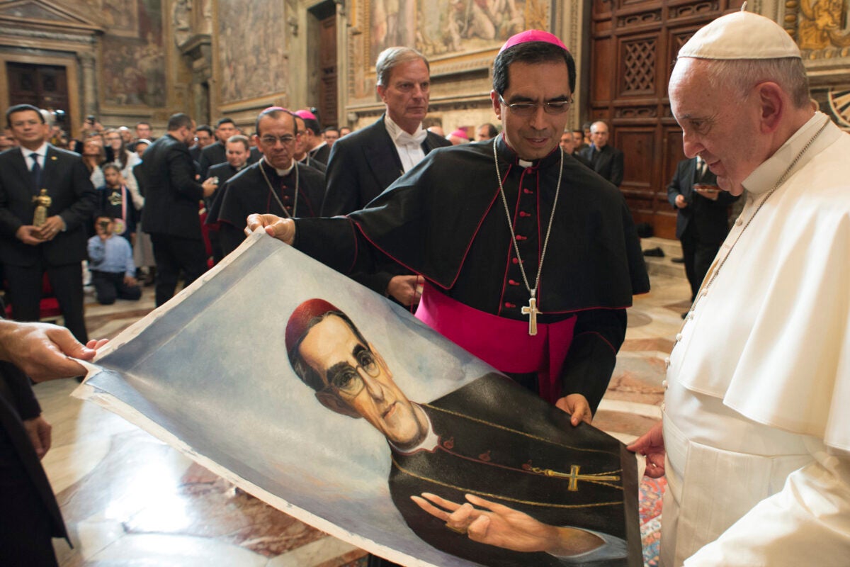 Pope Francis is presented with an image of Archbishop Oscar Romero at the Vatican in 2015.