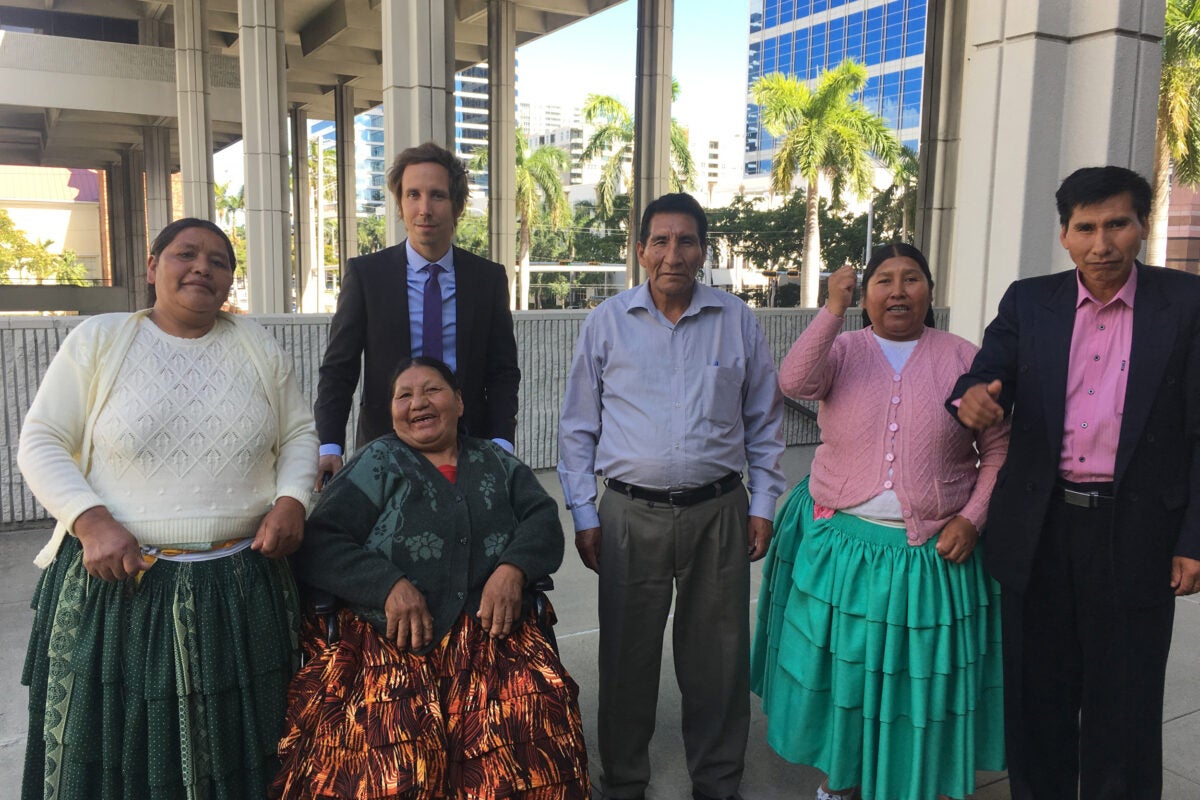 Thomas Becker, J.D. '08 (second from left), with relatives of the eight people slain in a 2003 Bolivian massacre who are suing their former president for the killings with the help of the Human Rights Program at HLS.