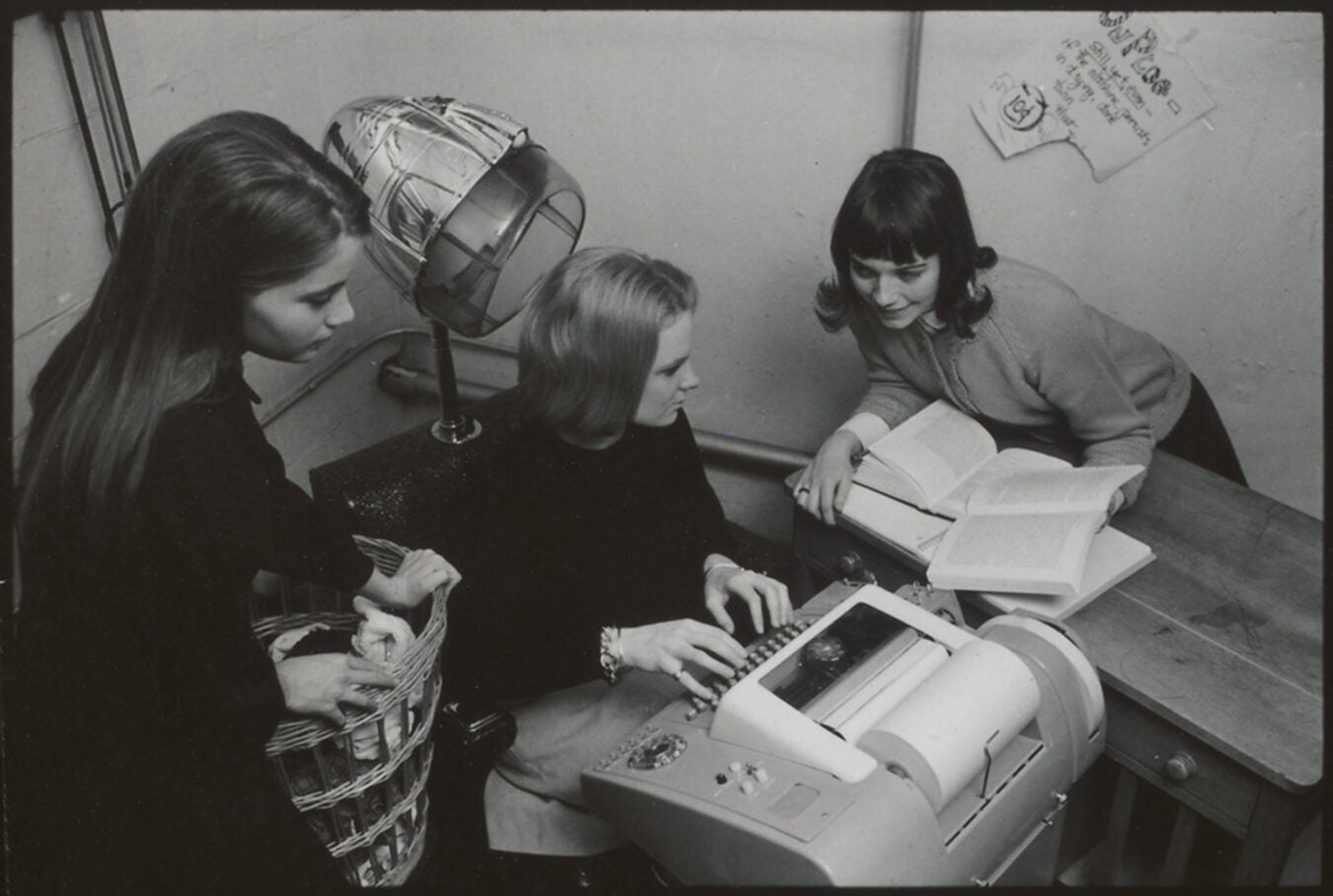 Radcliffe students circle a computer keyboard in basement of Cabot Hall, Feb. 8, 1966.