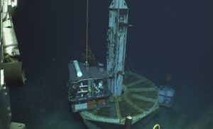 Researchers drill wells into the ocean floor.