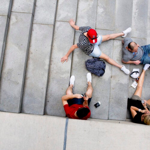 A red cap, T-shirt, and pair of shoes brighten the steps of Widener Library.