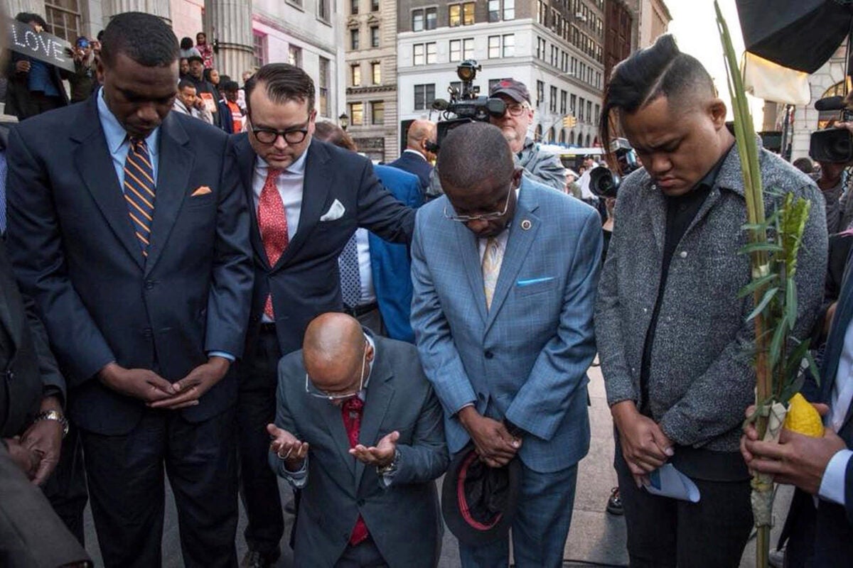 Evan Bernstein (second from left), New York regional director of the Anti-Defamation League and a Harvard Extension School graduate, participates in an interfaith prayer vigil outside Brooklyn Borough Hall after last year's mass shooting in Las Vegas. 