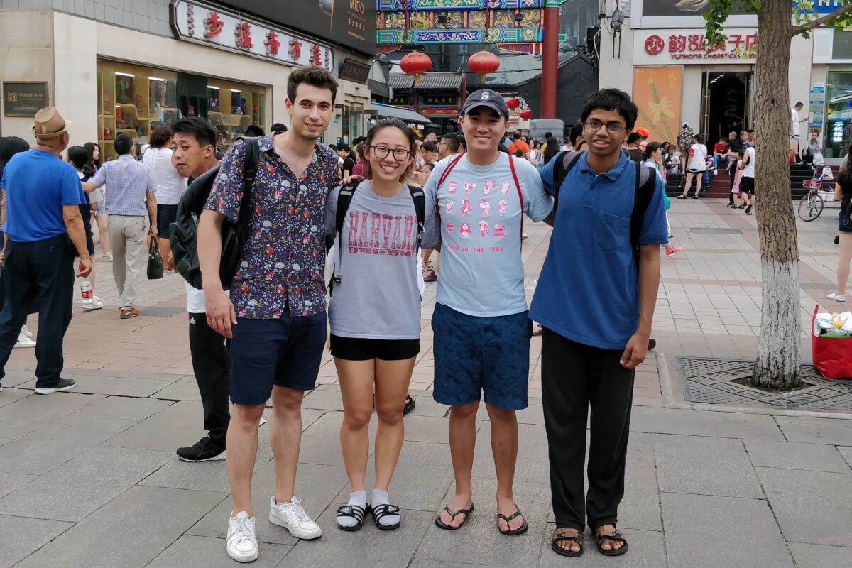 Harvard undergraduates Andrei Iliescu (from left), Irene Lu, Caleb Ren, and Adytia Mahadevan enjoy sightseeing on a cultural trip to Dong Hua Men Market. 