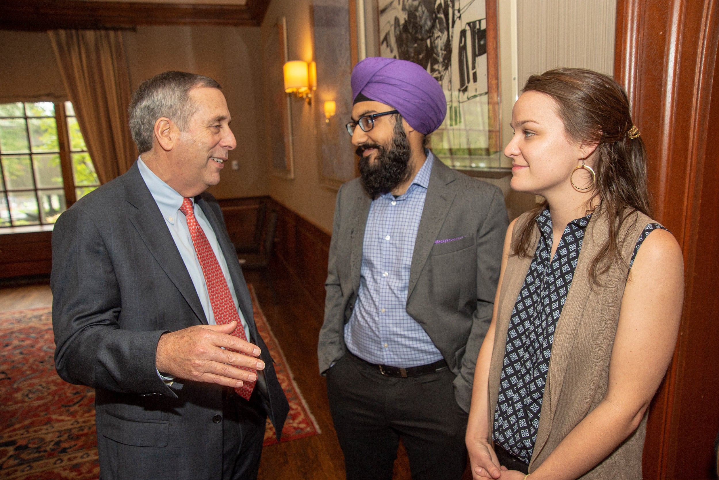 President Bacow, Harmann Singh (center), Sarah Bourland.