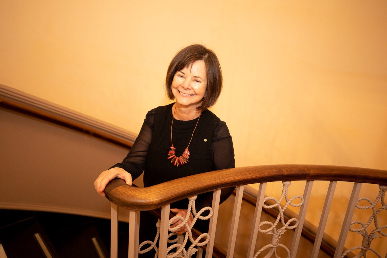Geraldine Brooks poses on Houghton Library staircase.