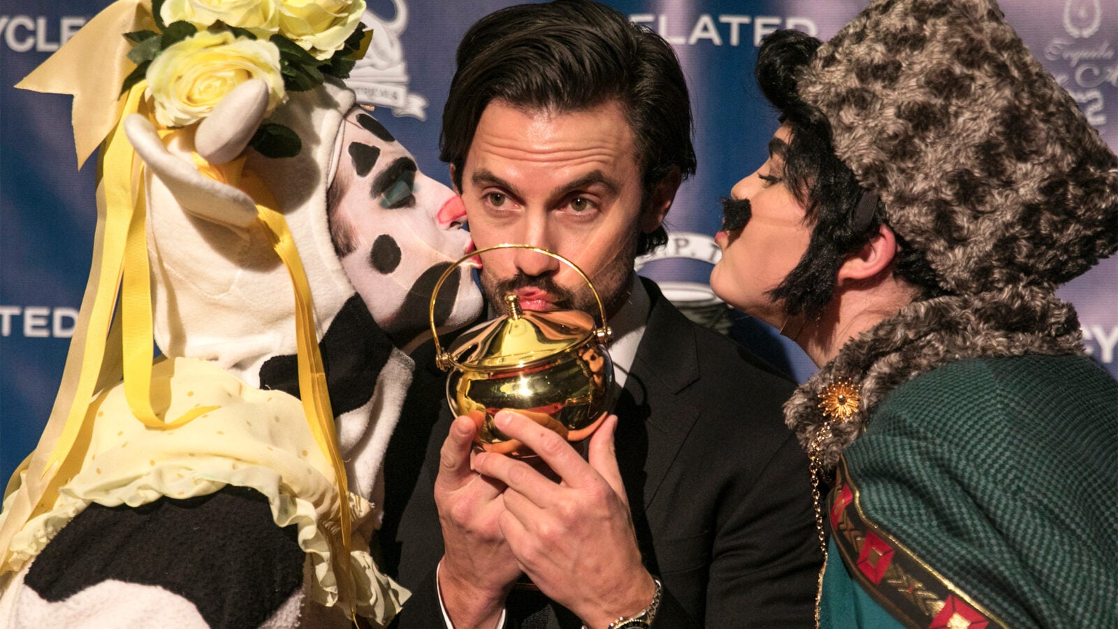 r Milo Ventimiglia kisses his pudding pot, flanked by Hasty Theatrical members Ryan Kapur '20 and Elle Shaheen '21.
