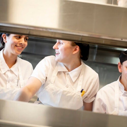 Chefs, Vanessa Portiza Acosta, from left, Corrine Gaucherin and Luz Restrepo Rincon work on the line in the kitchen at The Heights