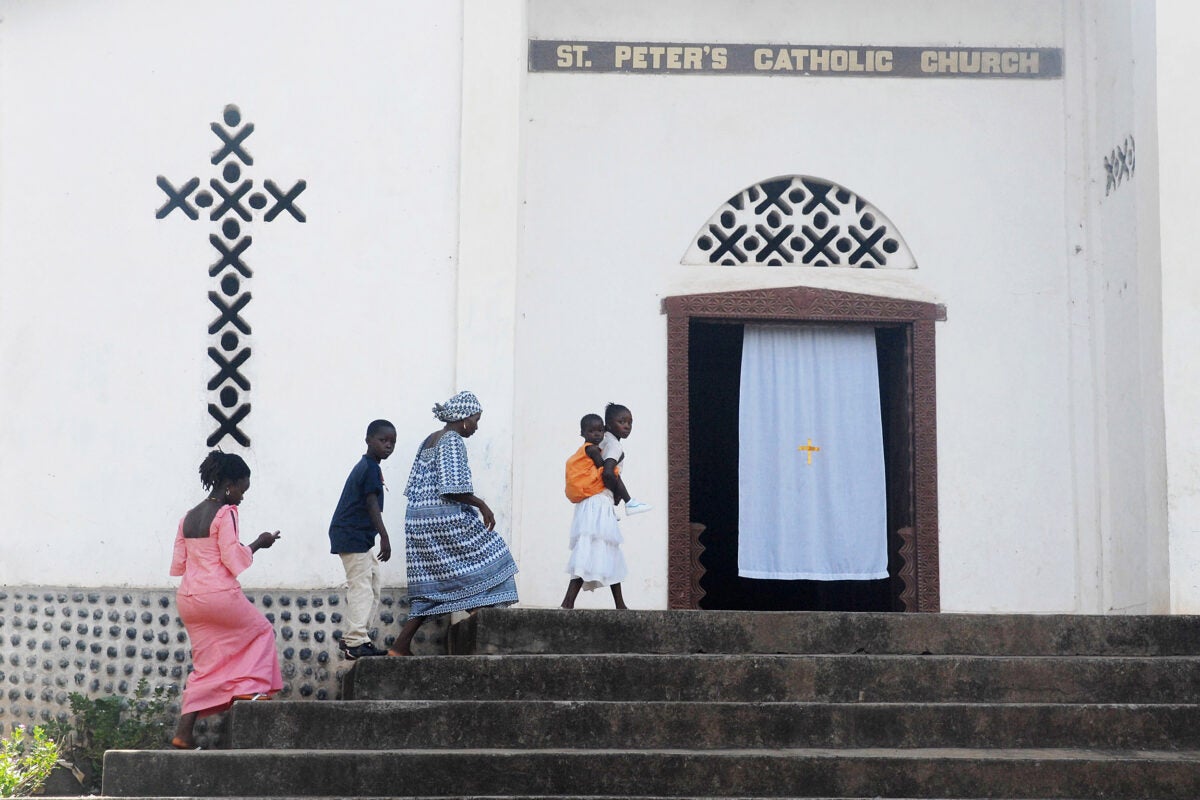 Worshippers arrive for Sunday mass at St. Peter's Church in Kamakwie, Sierra Leone.