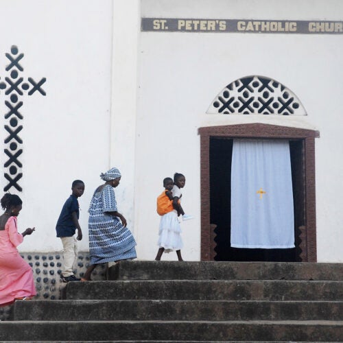 Worshippers arrive for Sunday mass at St. Peter's Church in Kamakwie, Sierra Leone.