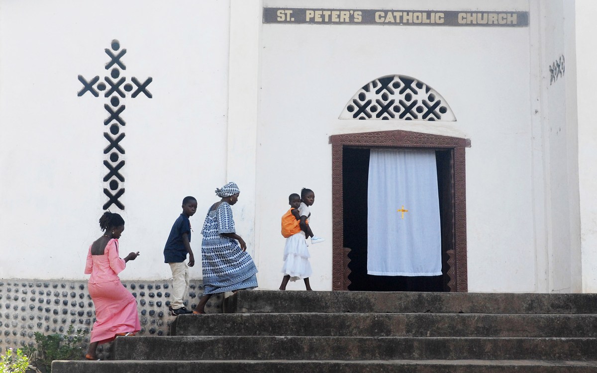 Worshippers arrive for Sunday mass at St. Peter's Church in Kamakwie, Sierra Leone.