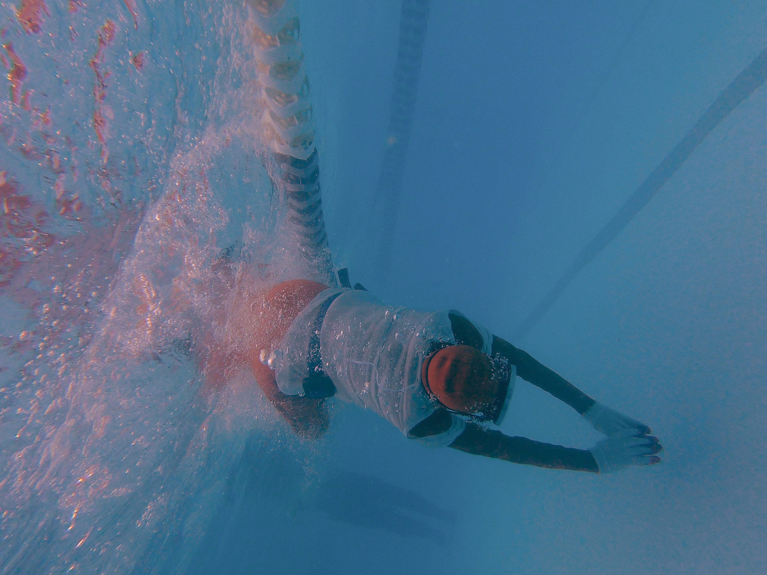 Jo Yang dives underwater.