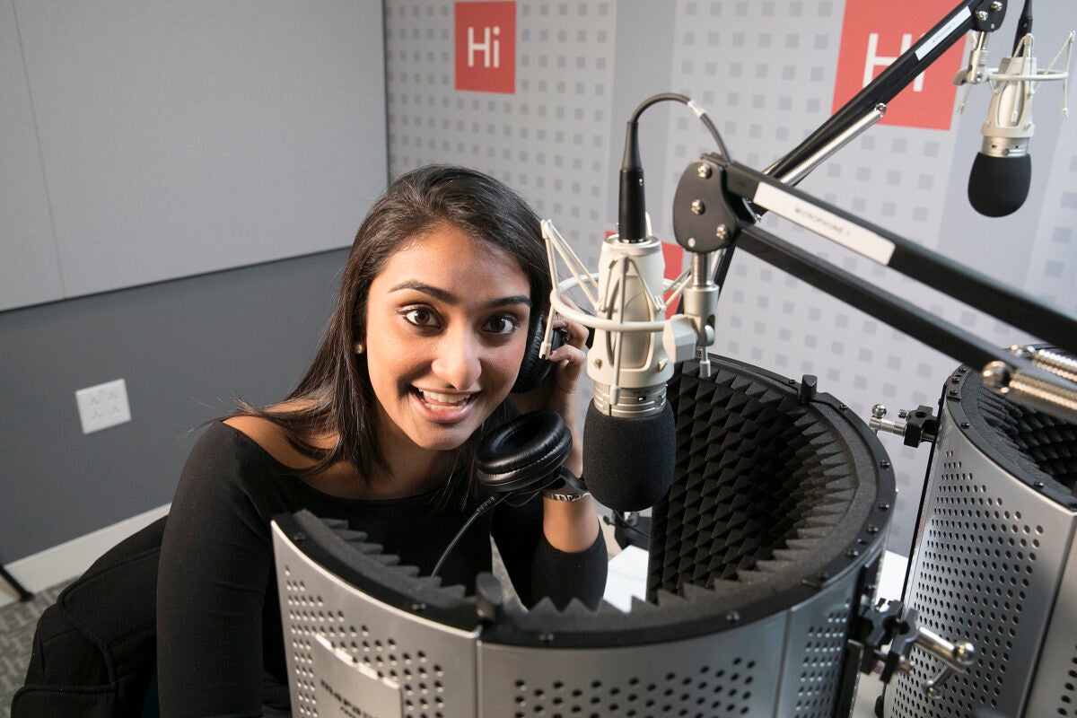 Shah talking into a microphone