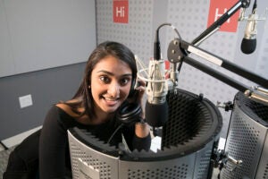 Shah talking into a microphone
