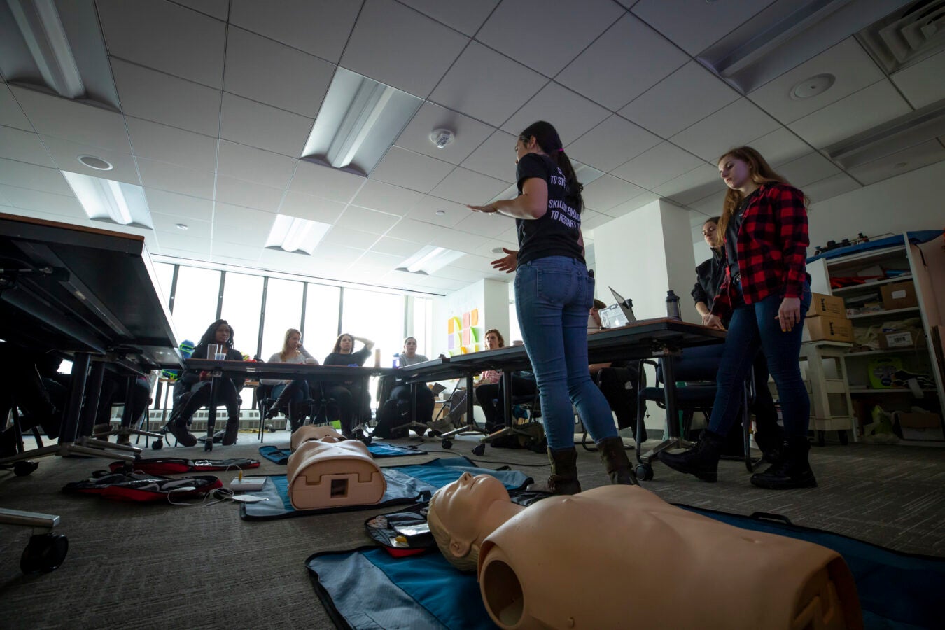 Students sit at desks in a CPR class.