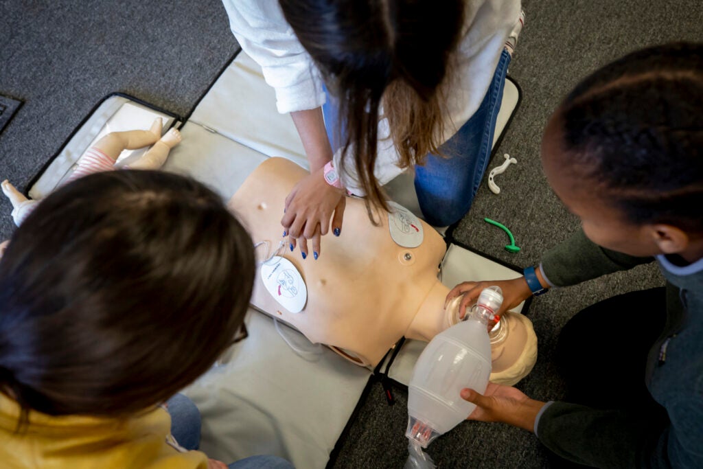 Students practice resuscitation using a dummy.