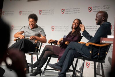 Panelists Carrie Mae Weems (from left), Sarah Lewis, and David Adjaye share a laugh onstage at the "Vision & Justice” conference. 