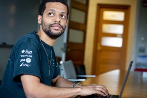 Jelani Nelson sitting in front of a laptop