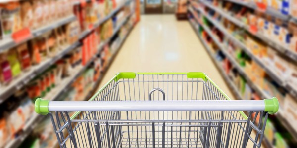 Supermarket aisle with empty shopping cart