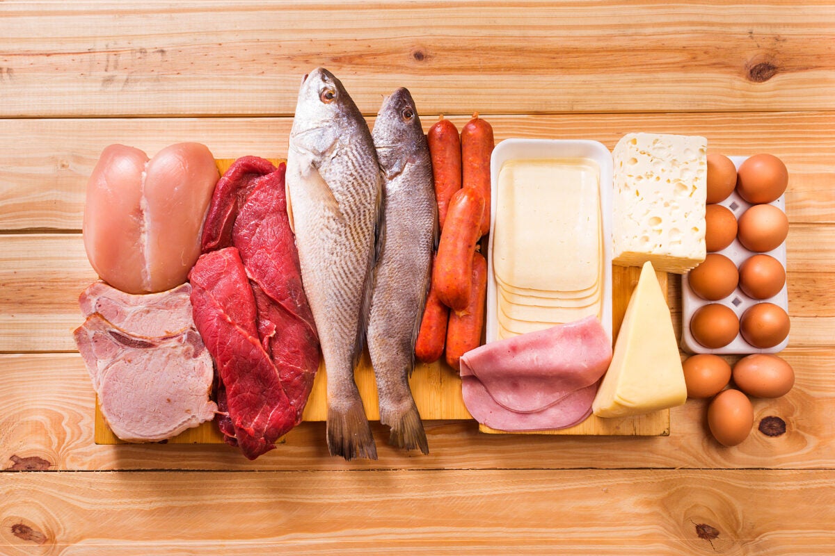 meats, fish, dairy, eggs, white meat on a wooden table as background
