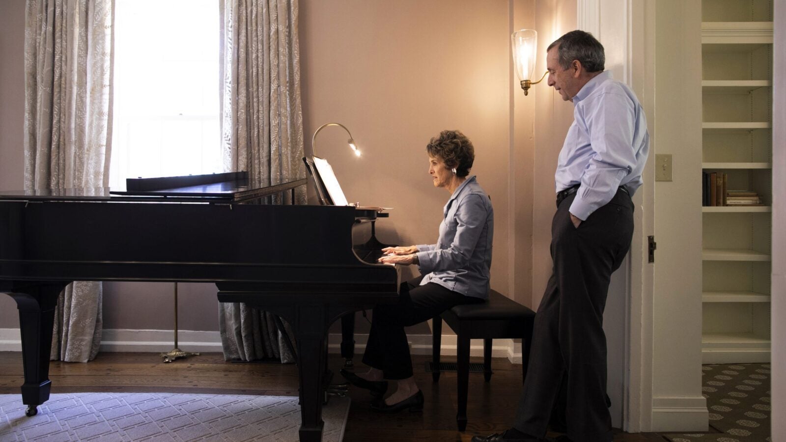 Adele Fleet Bacow playing the piano for husband, Larry Bacow.