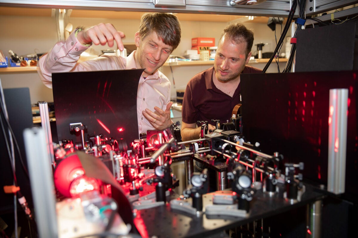 Researchers Adam Cohen and Yoav Adam examine their experiment in the lab