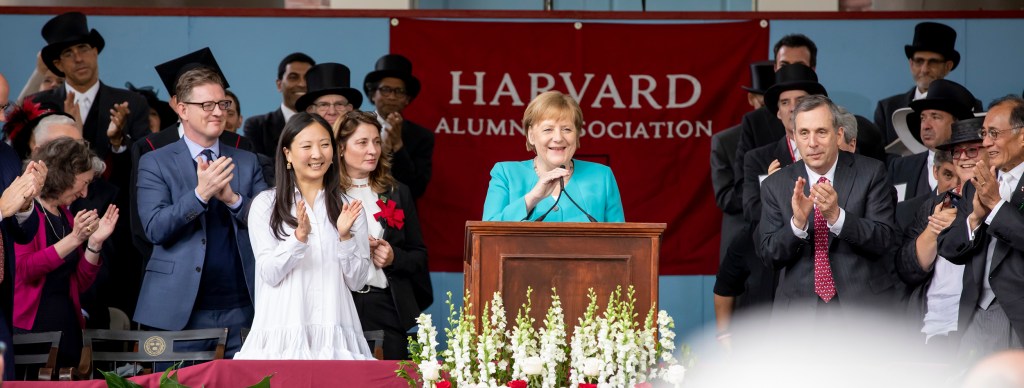 Angela Merkel speaks from podium.