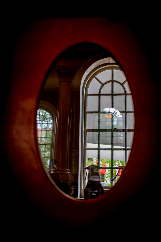 Senior reflected in window during Baccalaureate services in Memorial Church.