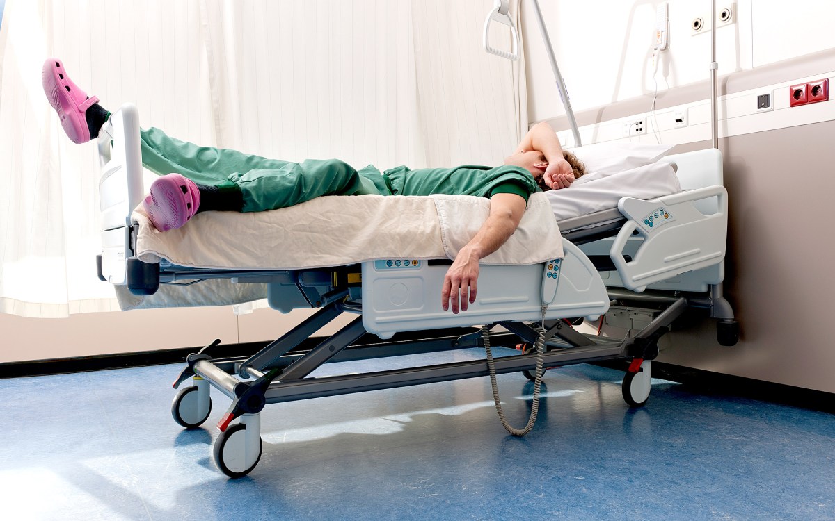Medical resident sleeping on hospital ward