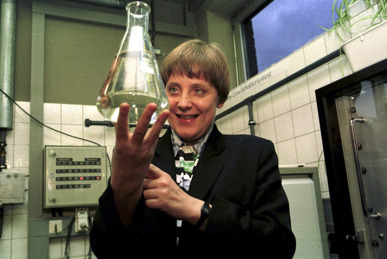 Angela Merkel holds a beaker in 1995.