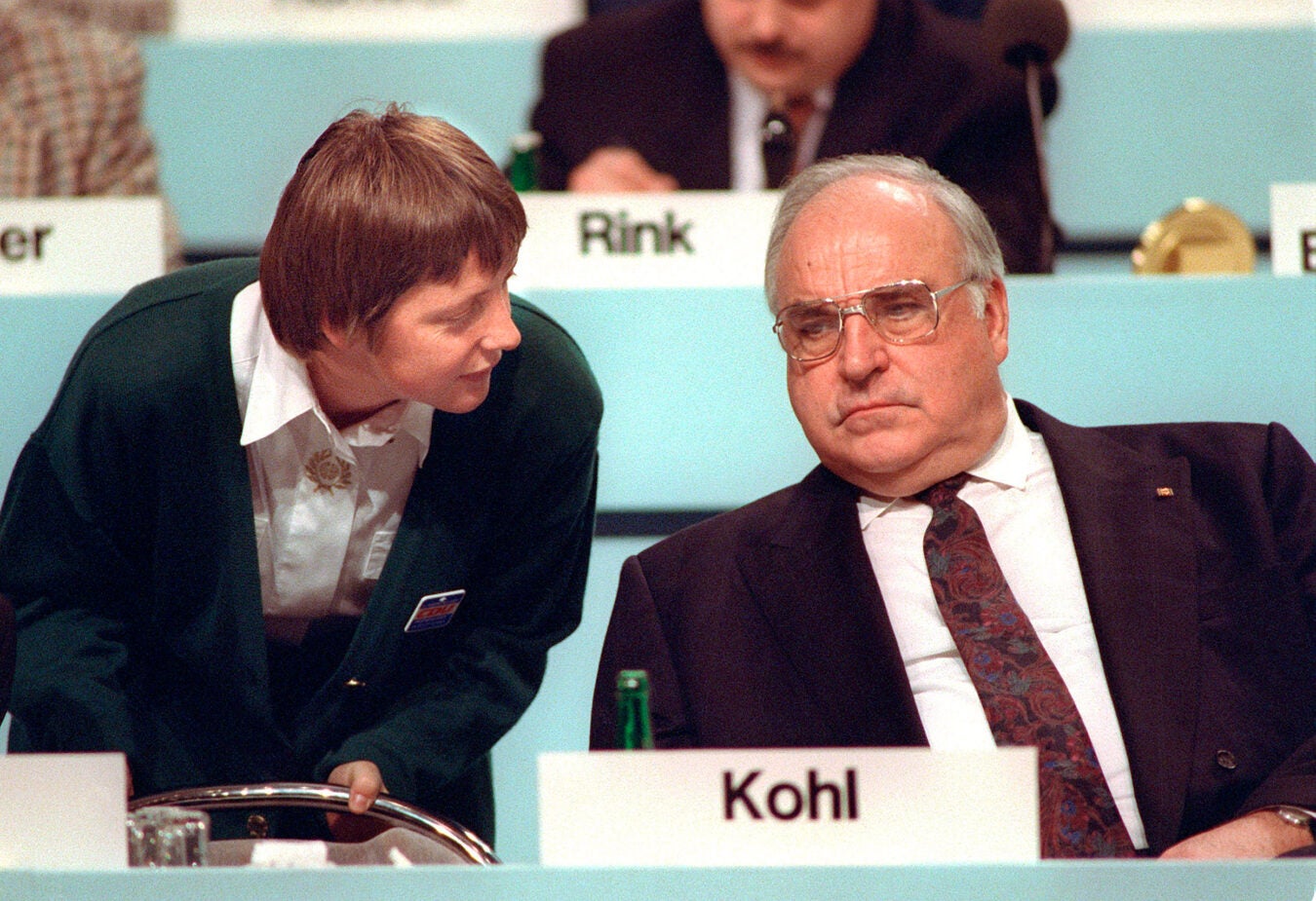 Angela Merkel talks to her mentor, Chancellor Helmut Kohl, in 1991.