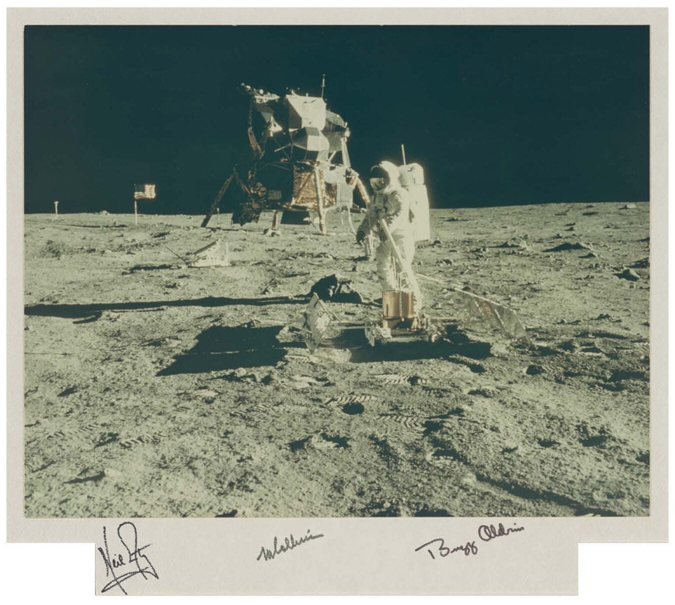Buzz Aldrin deploys a seismometer to detect moonquakes and meteoroid impacts.