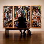 A visitor takes a photo of a painting on the wall at the Harvard Art Museum.