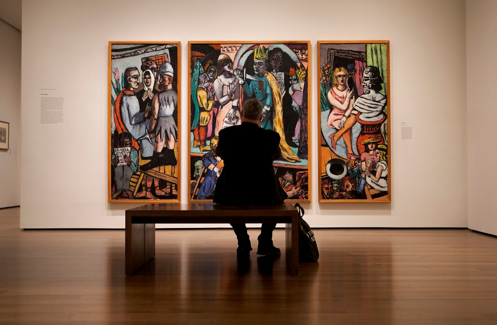 A visitor takes a photo of a painting on the wall at the Harvard Art Museum.