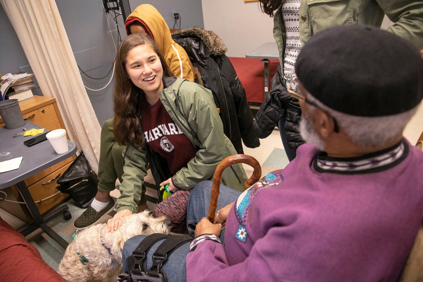 Student and dog visiting residents of rehab center.