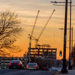 Building under construction in front of a sunset