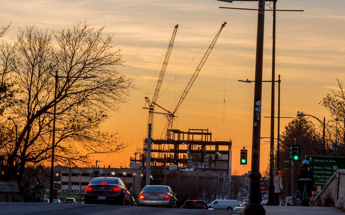 Building under construction in front of a sunset