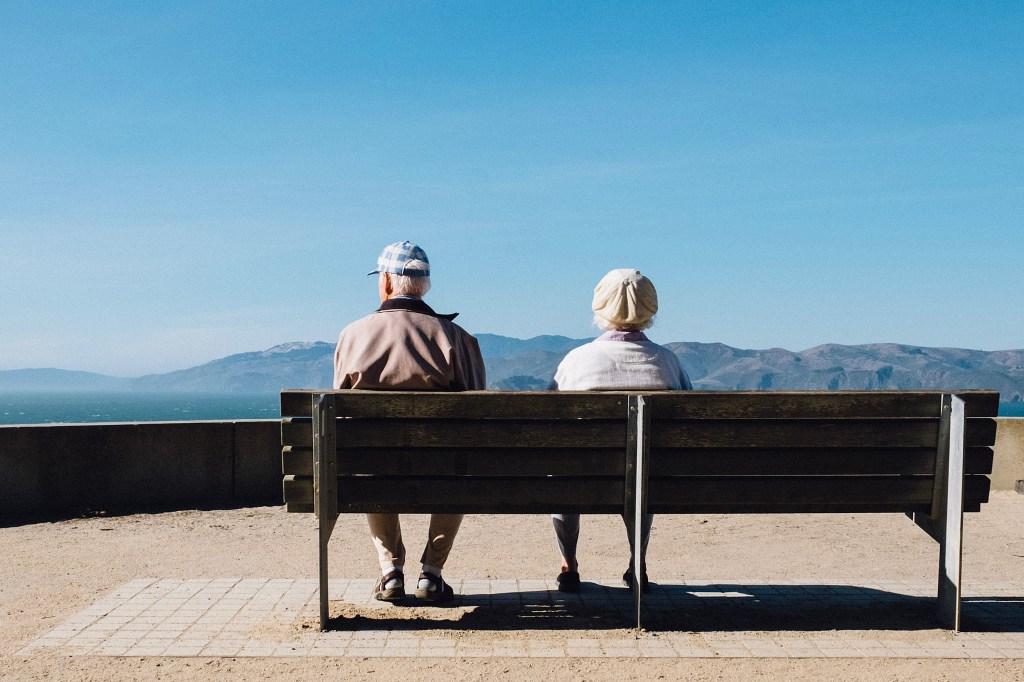 Two people sitting on a bench