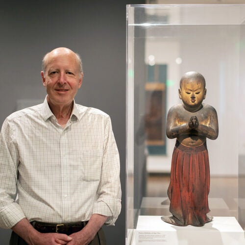 Walter Sedgwick stands next to Japanese statue
