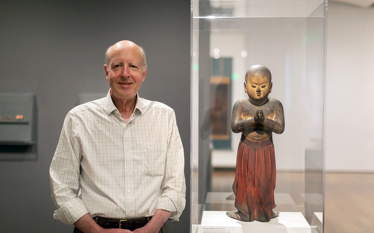 Walter Sedgwick stands next to Japanese statue