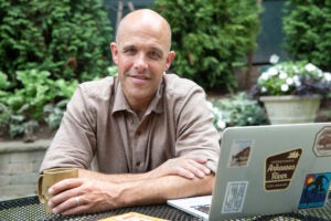 Pieter Cohen sitting in front of a laptop