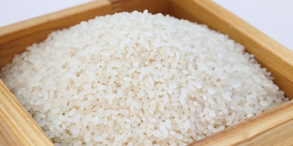 Uncooked rice in a wooden container