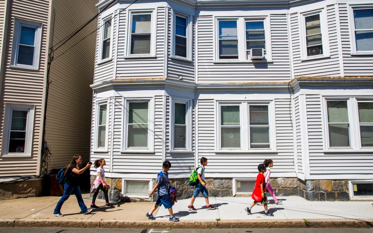 Children walking by a house