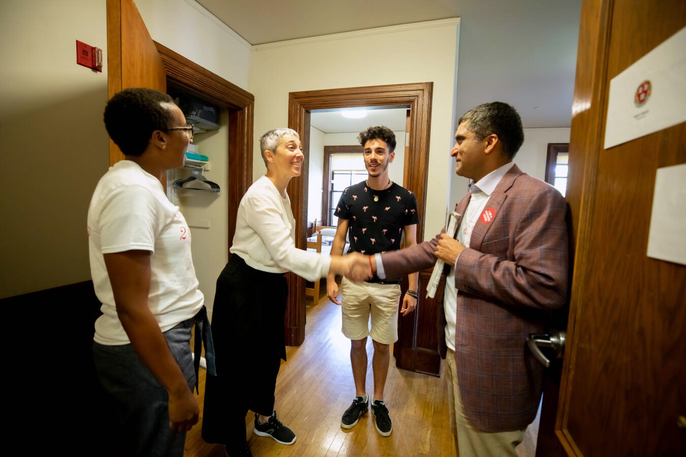 Deans greet a parent and student
